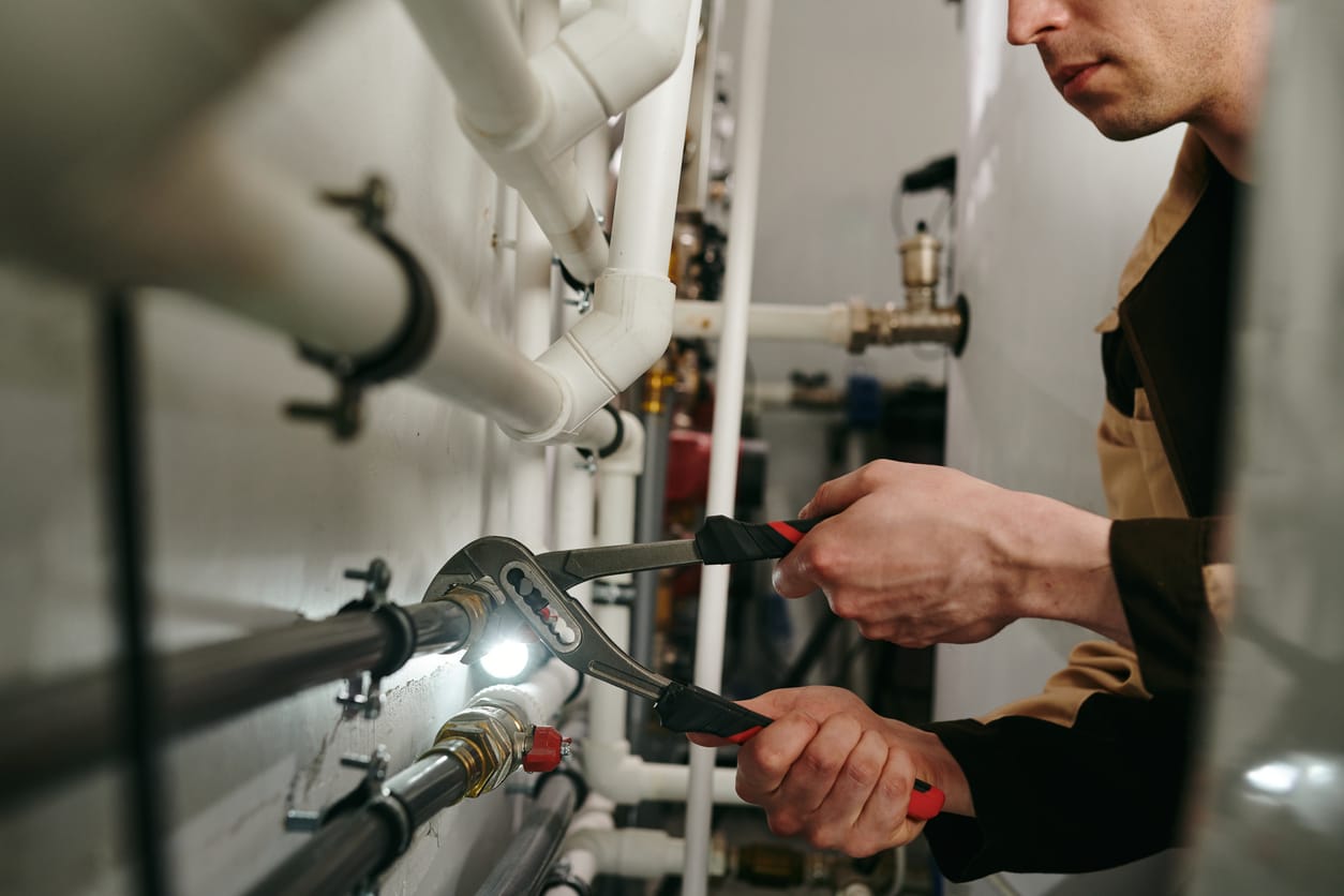 Plumbers maintaining commercial plumbing pipes in Brighton